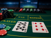 Close-up of a baccarat table showing cards and poker chips